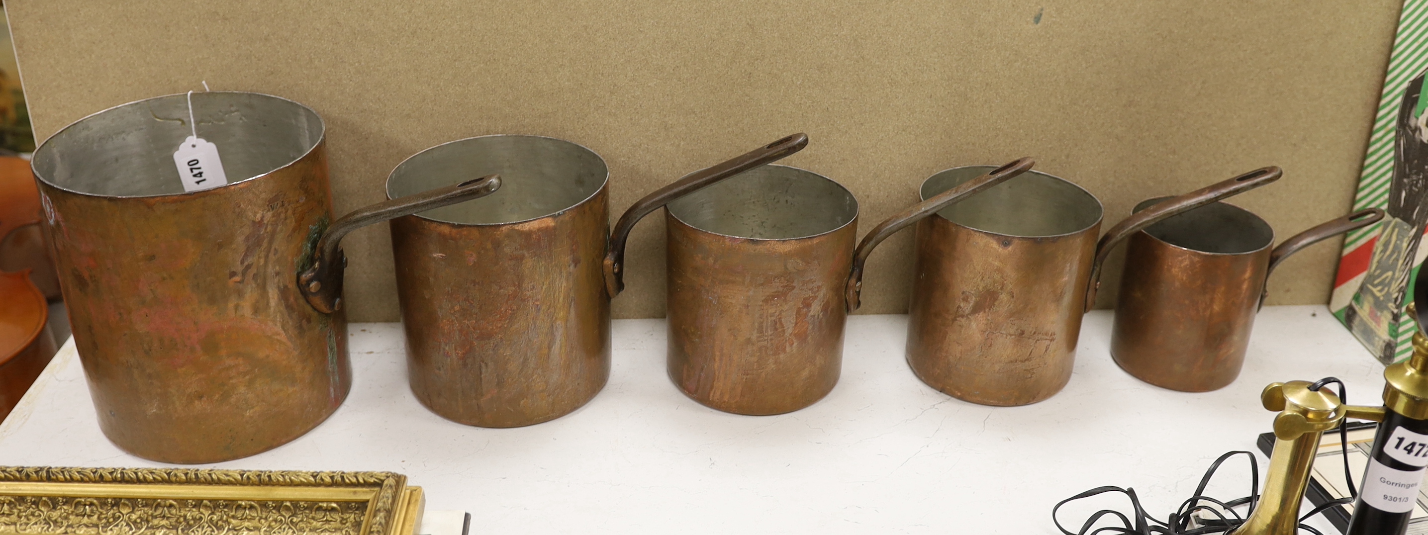 A set of five graduated copper saucepans